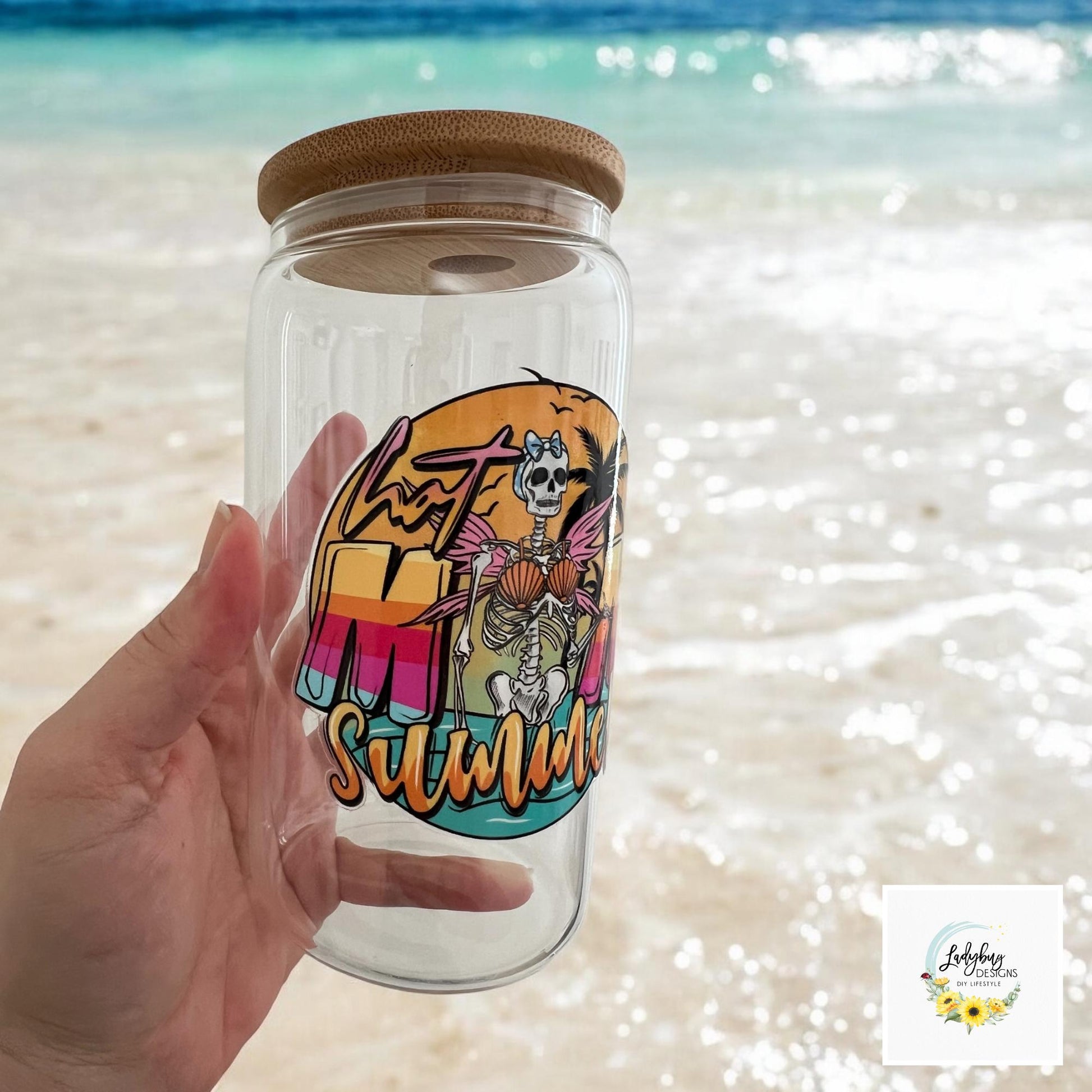 Hot Mom Summer Cup with bamboo lid and plastic straw. Features a 16 oz beer can glass design with permanent UV DTF transfer. Perfect for iced coffee and summer vibes. Ideal as a funny and sarcastic gift, with hand wash care instructions.