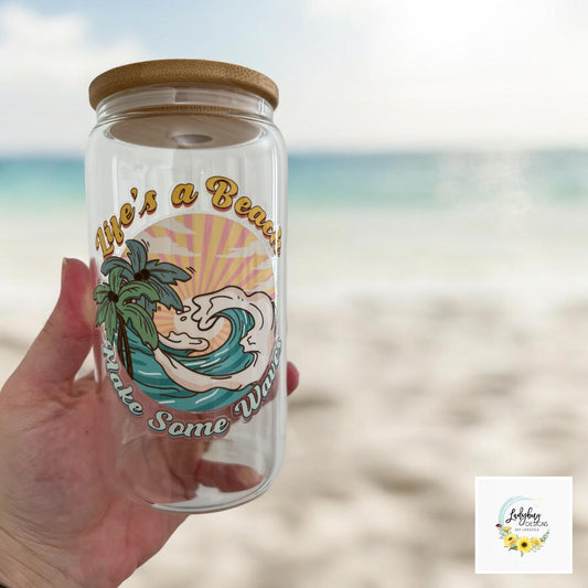 Life&#39;s a Beach Make Some Waves Cup with bamboo lid and plastic straw. Features a 16 oz beer can glass design with permanent UV DTF transfer. Perfect for iced coffee and summer vibes. Ideal as a funny and sarcastic gift, hand wash care instructions.