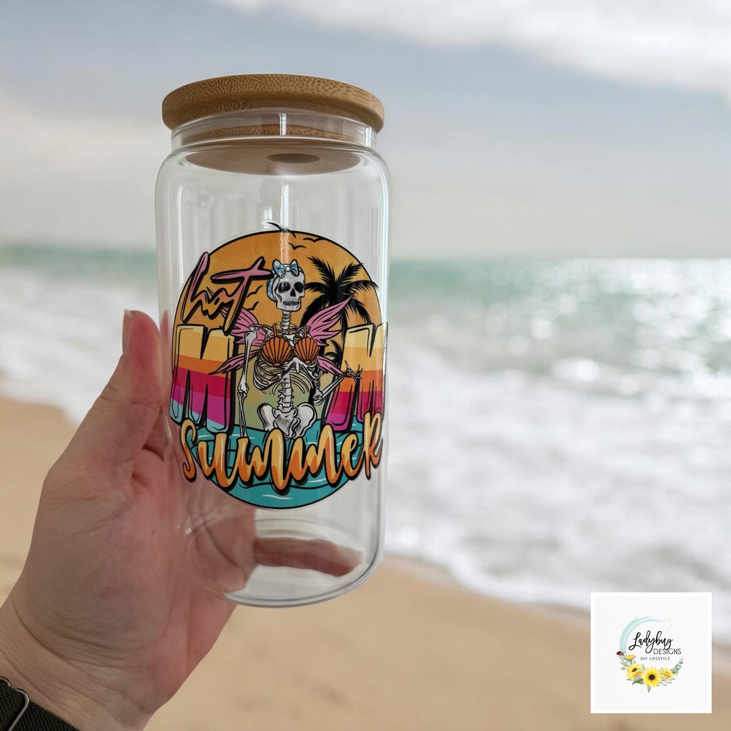 Hot Mom Summer Cup with bamboo lid and plastic straw. Features a 16 oz beer can glass design with permanent UV DTF transfer. Perfect for iced coffee and summer vibes. Ideal as a funny and sarcastic gift, with hand wash care instructions.